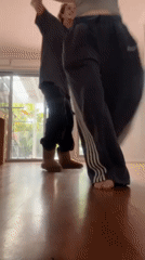 Couple captures playful moments dancing and taking selfies indoors