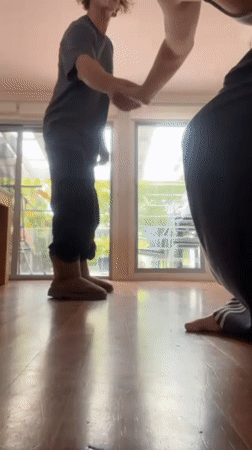 Couple captures playful moments dancing and taking selfies indoors
