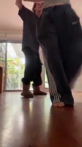 Couple captures playful moments dancing and taking selfies indoors