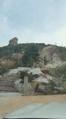 Car drives up hill road in Muddenahalli, India