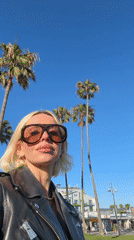 Woman photographed near Venice palm trees early morning