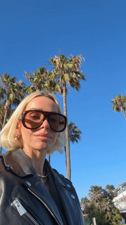Woman photographed near Venice palm trees early morning