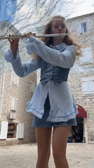 Street musician plays flute on cobblestones in Budva