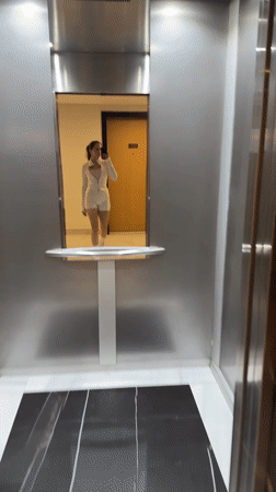 Woman takes elevator selfie in Dubai building