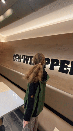 Woman has meal at Burger King in Budva