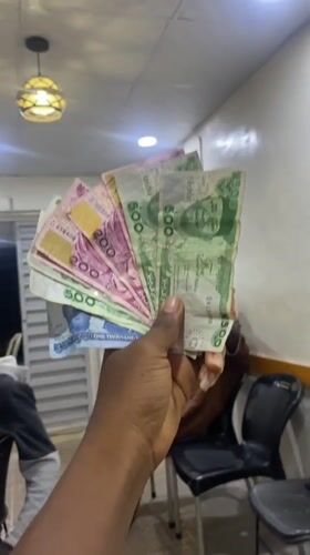 Person displays Nigerian currency notes in Lagos