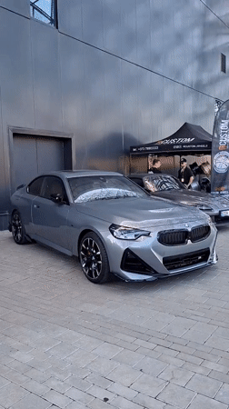 BMW M2 parked outside a modern building in Stăuceni