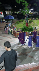 Religious procession with purple-robed participants in Timana, Colombia
