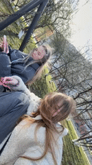 Two women use park swings in Chaikovsky, Russia