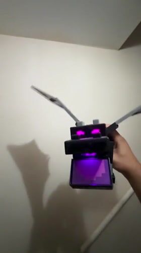 Block dragon with glowing purple eyes on display in Leominster