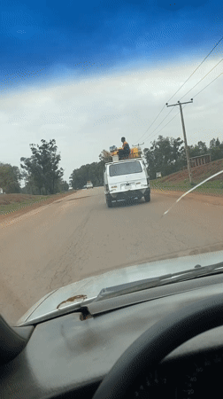 Loaded van travels cracked road in Durimi, Nigeria