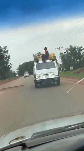 Loaded van travels cracked road in Durimi, Nigeria