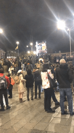 Crowds gather with Bolivian flags at nighttime La Paz demonstration
