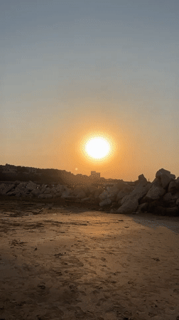 Caspian beach at golden hour, Baku coastline buzzing