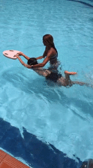 Children swimming at resort pool in Phú Thủy, Vietnam