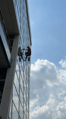 Window washers clean office building facade in Dolgoprudny