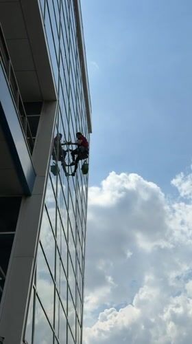 Window washers clean office building facade in Dolgoprudny