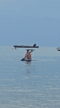 Boats dock in calm Búzios harbor under clear skies