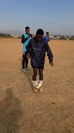 Young men practice soccer juggling skills on Nigerian field