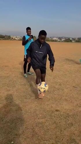 Young men practice soccer juggling skills on Nigerian field