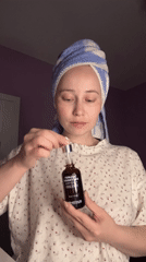 Woman performs evening skincare routine in Saint Petersburg bedroom