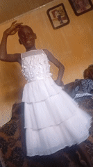 Young person poses in two party dresses during photo session