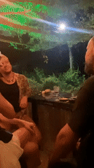 Three people gather at outdoor bar in Thailand