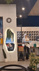 Street musician performs at busy Indonesian cafe during afternoon