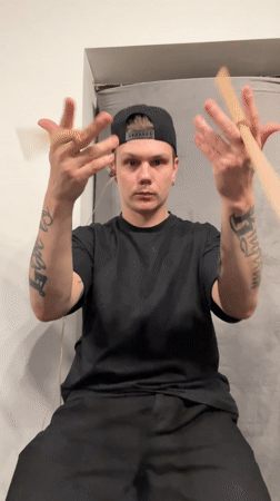Tattooed drummer practices stick movements in Шemyakino, Russia
