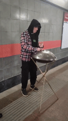 Street musician plays hang drum in Moscow underpass