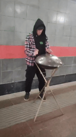 Street musician plays hang drum in Moscow underpass