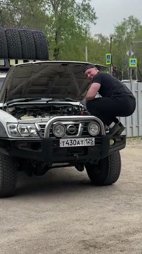 Man repairs engine of 4WD vehicle in Blagoveshchensk