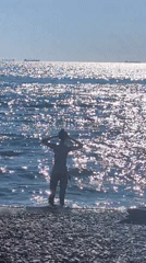 Early morning at an Odesa pebble beach, ships on the horizon
