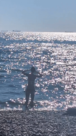 Early morning at an Odesa pebble beach, ships on the horizon