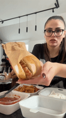 Woman enjoys takeout meal with cat in Plovdiv