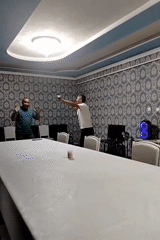 Relaxed indoor hangout with dancing, play-fighting, and grilled skewers