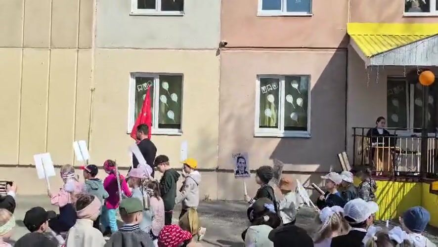 Children commemorate Victory Day with flags in Tobolsk, Russia