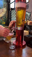 Man pours beer at American-themed restaurant in Đà Nẵng