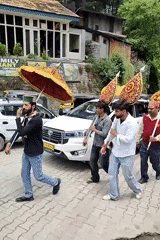 Religious procession and street vendors in morning Manali