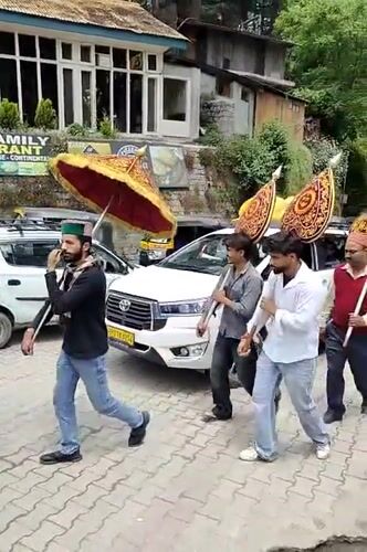 Religious procession and street vendors in morning Manali