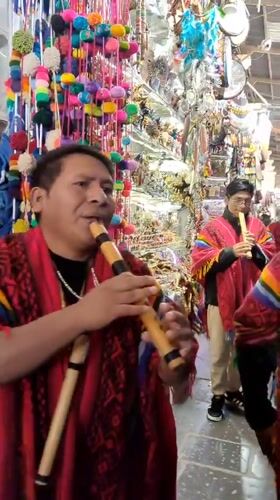Political campaign event features traditional musicians in Cusco market