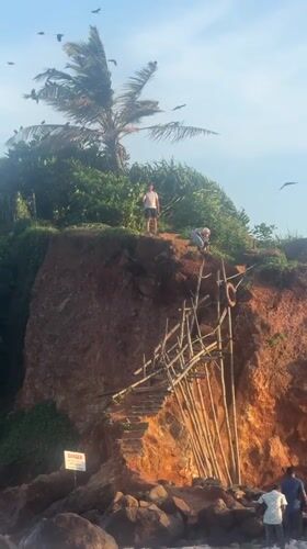 Man observes ocean view from clifftop in Thalaramba, Sri Lanka