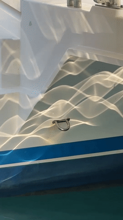 Sunlit boat hull on the water in Fethiye