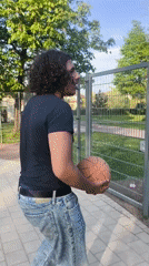 Man enjoys afternoon recreation at Strasbourg park and basketball court