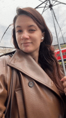 Woman enjoys rainy afternoon in Belgrade's Savamala district