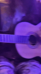 Intimate acoustic jam session in a candlelit Vashisht room