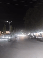 Nighttime traffic flows through illuminated Lhokseumawe streets