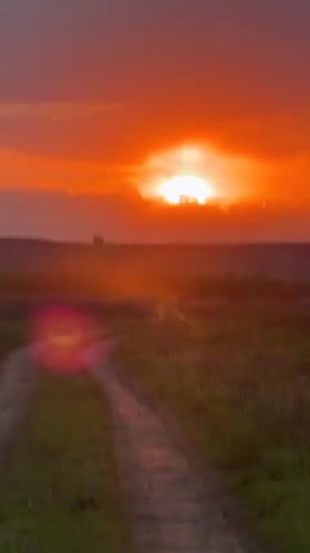 Sunset captured on dirt road through Russian field