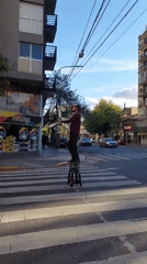 Street performer juggles on pedestrian crossing in Buenos Aires