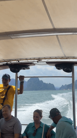 Passenger boat travels through Thai waters near mountains